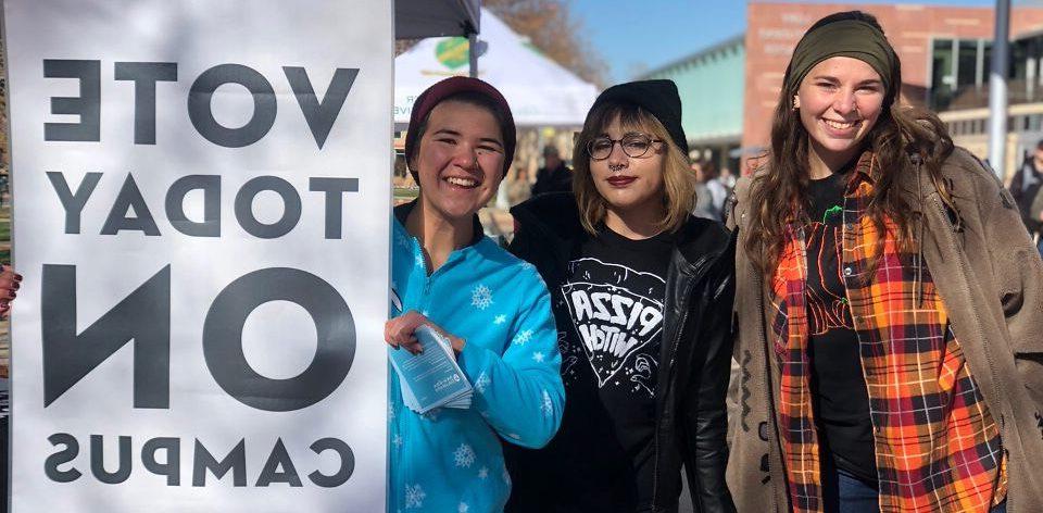 Photo of students with a sign that says 