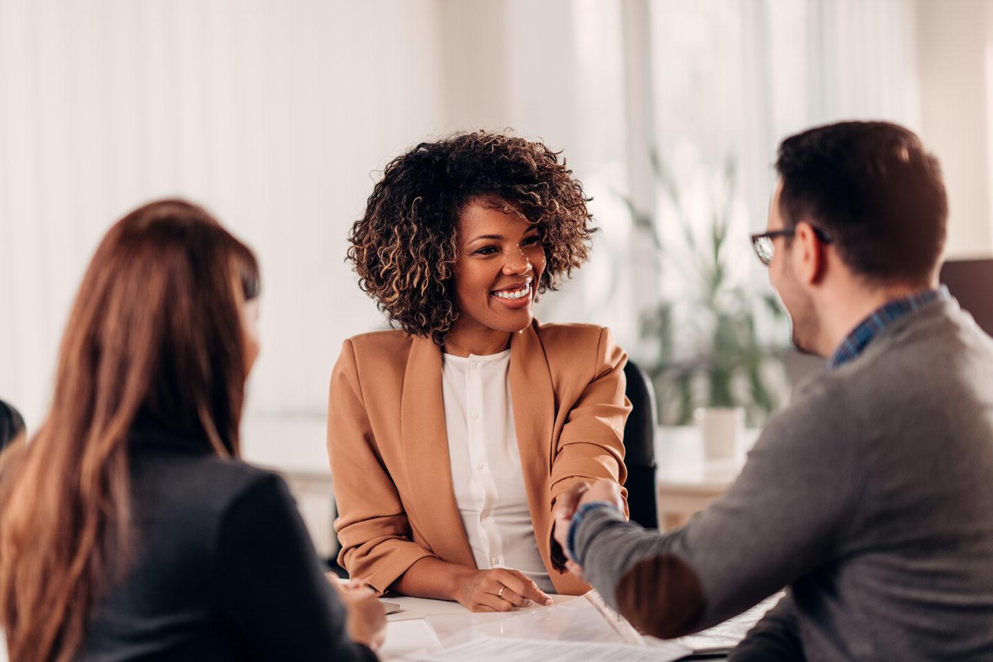 Business people shaking hands after successful meeting