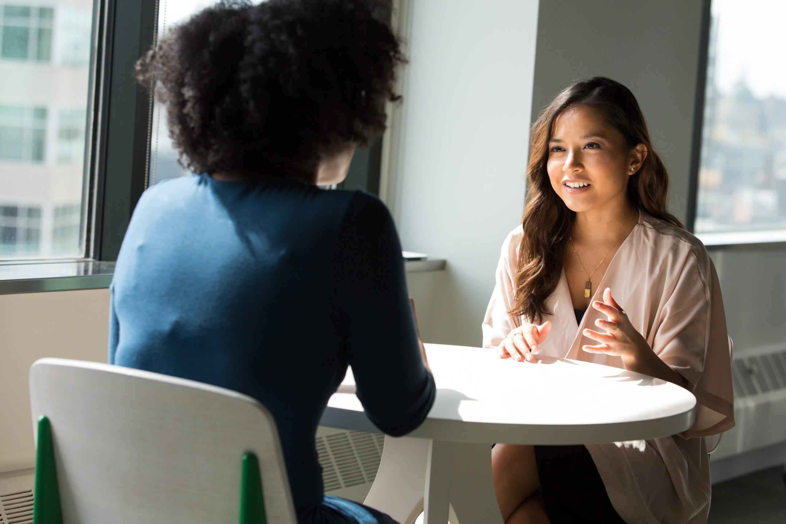 Two people talking at a table