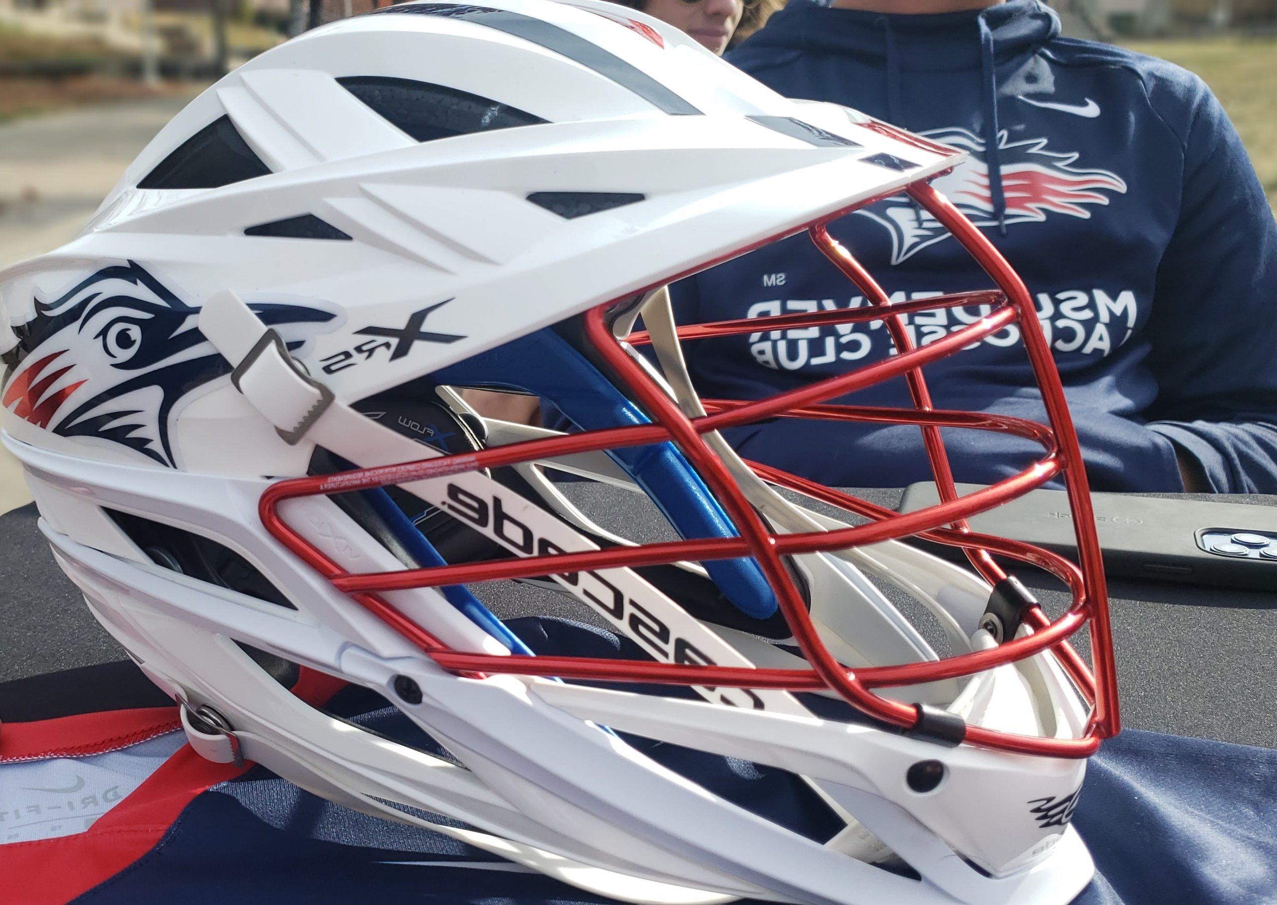 A Club Lacrosse helmet sitting on a table