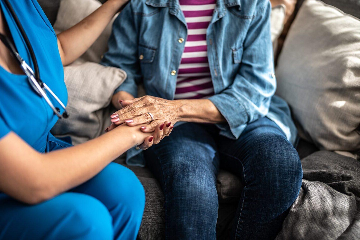 Person holding hands with an older adult