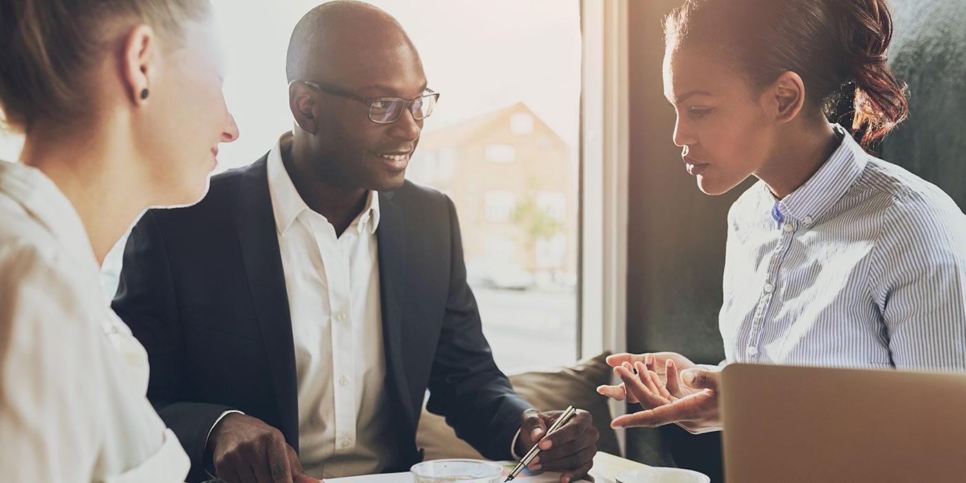 Three people in a business meeting